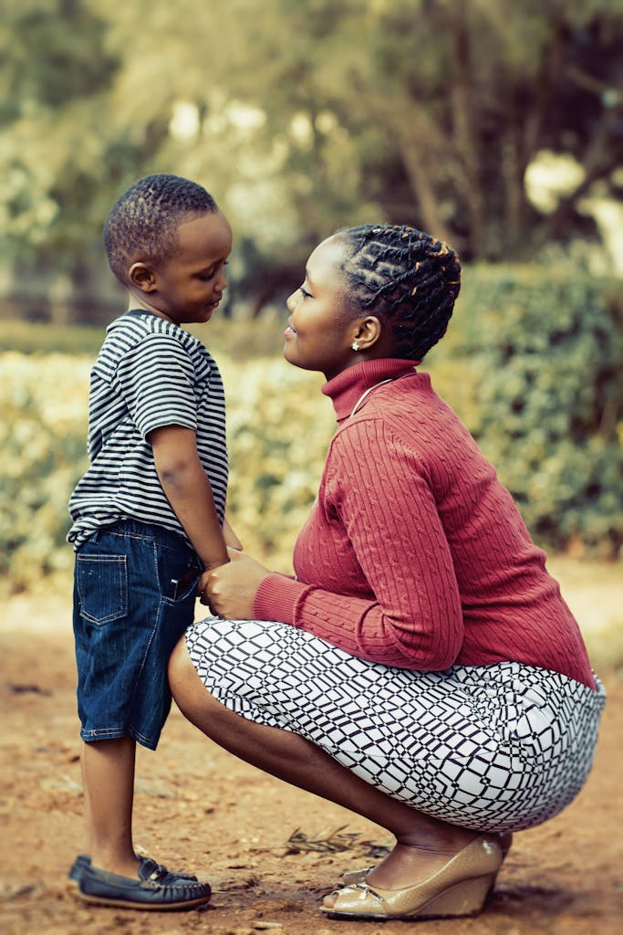 A heartfelt moment between a mother and son outdoors in Kenya, capturing love and connection.